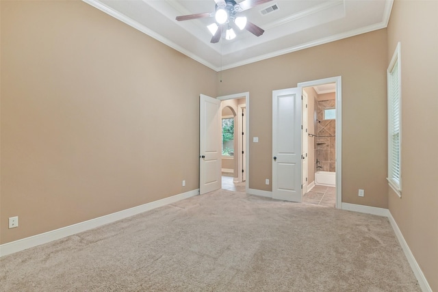 13622 Kluge Corner Ln, Cypress, TX 77429 - unfurnished bedroom featuring light carpet, ornamental molding, a tray ceiling, ensuite bathroom, and a ceiling fan