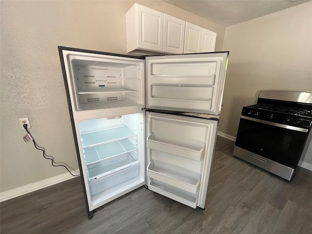 4831 Sycamore Ave Unit 16, Pasadena, TX 77503 - kitchen with stainless steel gas range, dark wood-style flooring, white cabinets, and a textured ceiling