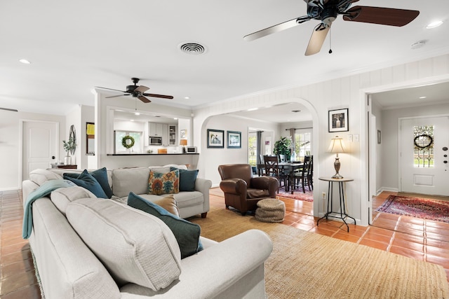 1219 Del Norte St, Houston, TX 77018 - living area with arched walkways, ceiling fan, healthy amount of natural light, tile patterned flooring, and ornamental molding