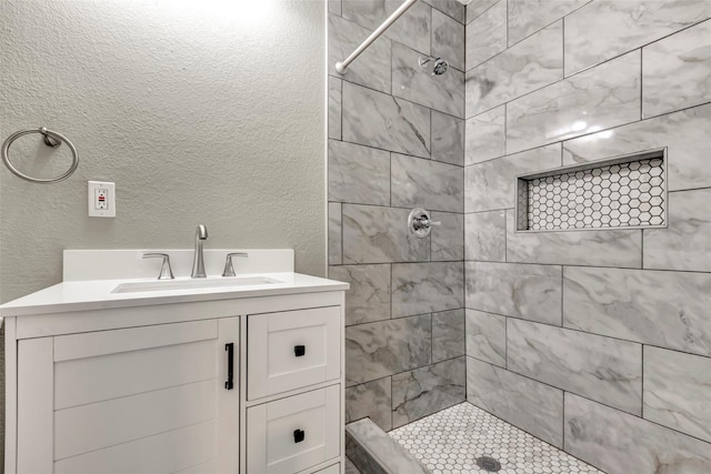 5955 Bellfort St, Houston, TX 77033 - bathroom with tiled shower, vanity, and a textured wall