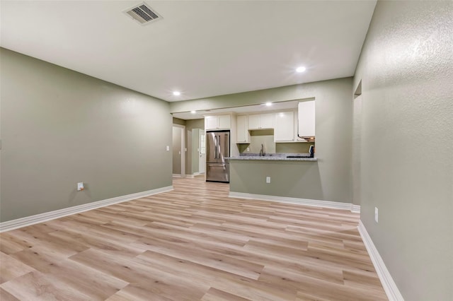 5955 Bellfort St, Houston, TX 77033 - unfurnished living room featuring light wood-style floors and recessed lighting