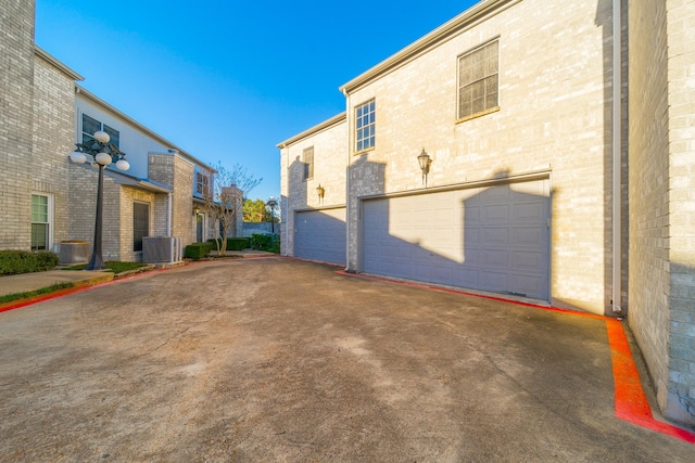 7256 Regency Square Ct Unit 7256, Houston, TX 77036 - view of side of property with an attached garage, driveway, and brick siding