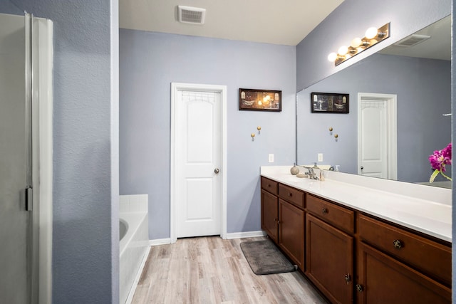 12614 Pelican Bay Dr, Houston, TX 77038 - full bath featuring vanity, wood finished floors, and a bath