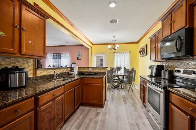12614 Pelican Bay Dr, Houston, TX 77038 - kitchen featuring stainless steel electric range, black microwave, light wood-style flooring, ornamental molding, and tasteful backsplash