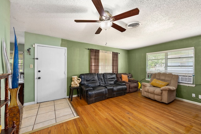 12337 Kayla Ln, Houston, TX 77015 - living area with ceiling fan, a textured ceiling, and light wood-type flooring