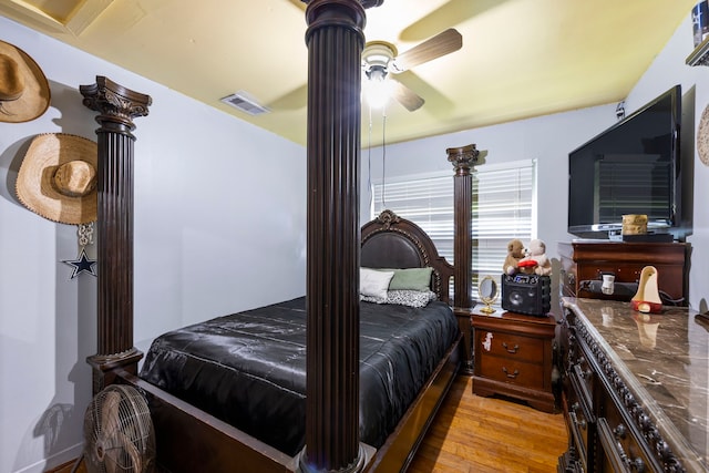 12337 Kayla Ln, Houston, TX 77015 - bedroom with light wood-style flooring, ceiling fan, and ornate columns