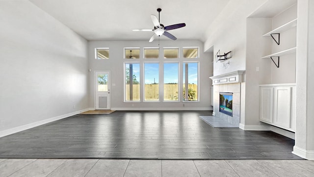 2135 Llerena Ln, League City, TX 77573 - unfurnished living room featuring a ceiling fan, a tile fireplace, and wood finished floors