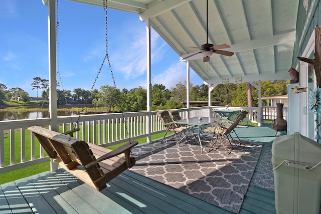 1575 Yaupon Cove Dr, Onalaska, TX 77360 - wooden terrace with a ceiling fan, a water view, outdoor dining space, and a yard