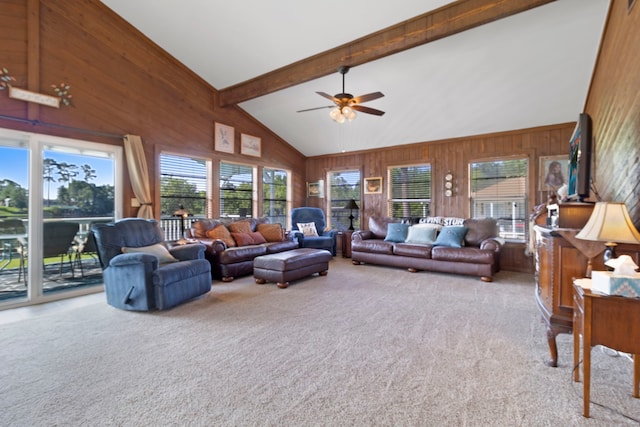 1575 Yaupon Cove Dr, Onalaska, TX 77360 - living area featuring carpet floors, ceiling fan, beamed ceiling, wood walls, and high vaulted ceiling