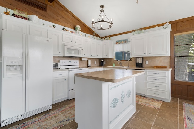 1575 Yaupon Cove Dr, Onalaska, TX 77360 - kitchen featuring white appliances, wood walls, vaulted ceiling, white cabinetry, and tasteful backsplash