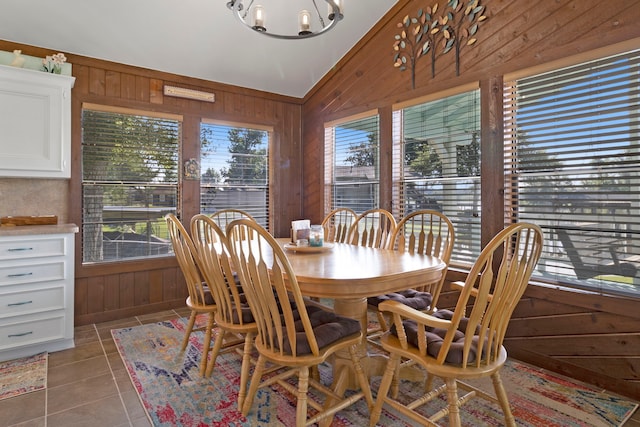 1575 Yaupon Cove Dr, Onalaska, TX 77360 - tiled dining space featuring wood walls, a chandelier, and lofted ceiling