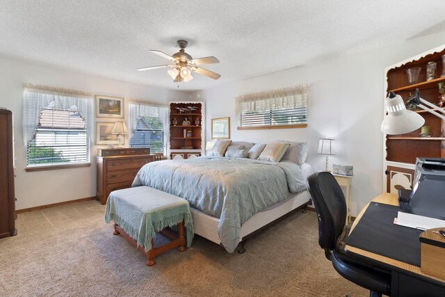 1575 Yaupon Cove Dr, Onalaska, TX 77360 - bedroom with light colored carpet, a desk, a textured ceiling, and ceiling fan