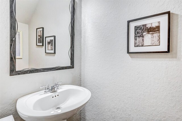 24030 Cannon Anello Ct, Katy, TX 77493 - bathroom with a textured wall and lofted ceiling