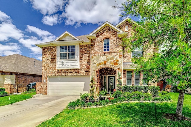 24030 Cannon Anello Ct, Katy, TX 77493 - view of front of home featuring an attached garage, driveway, a front yard, and brick siding