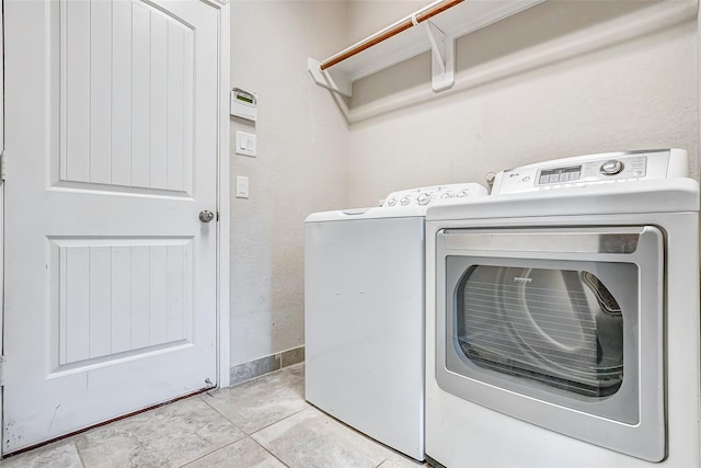 24030 Cannon Anello Ct, Katy, TX 77493 - washroom with washer and clothes dryer and light tile patterned floors