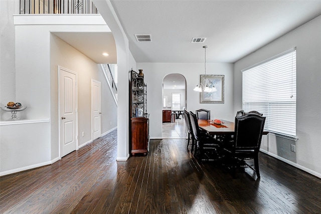 24030 Cannon Anello Ct, Katy, TX 77493 - dining room featuring arched walkways, wood-type flooring, and a chandelier