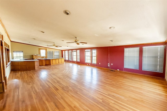 890 Rattlesnake Rd, Harker Heights, TX 76548 - unfurnished living room featuring light wood-style flooring, crown molding, plenty of natural light, ceiling fan, and lofted ceiling