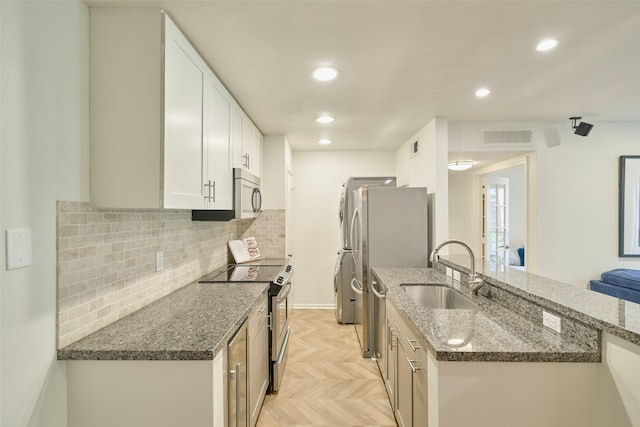 1601 S Shepherd Dr Unit 222, Houston, TX 77019 - kitchen featuring stainless steel appliances, backsplash, recessed lighting, white cabinetry, and dark stone countertops