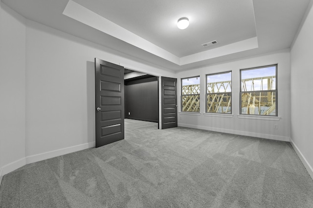 3232 Stingray Cove Dr, Katy, TX 77493 - unfurnished bedroom featuring a tray ceiling and carpet
