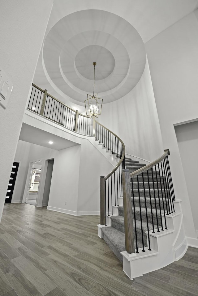 3232 Stingray Cove Dr, Katy, TX 77493 - staircase with a towering ceiling, wood finished floors, and a chandelier