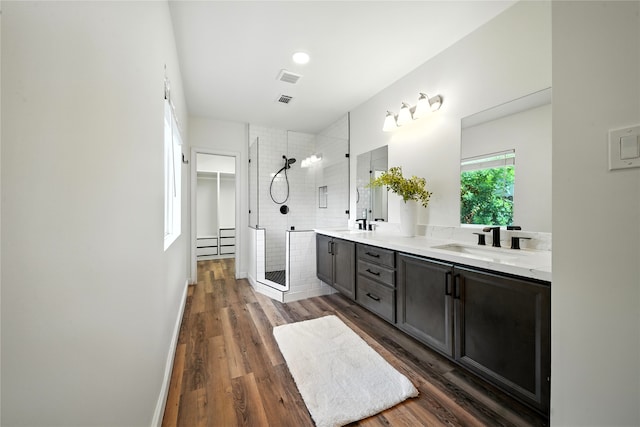 1610 Antoine Dr, Houston, TX 77055 - bathroom with a stall shower, double vanity, a spacious closet, and wood finished floors