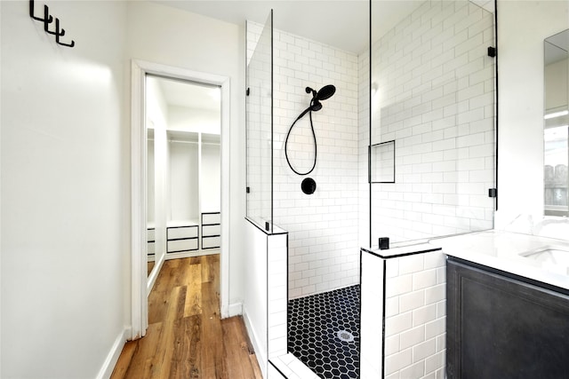 1610 Antoine Dr, Houston, TX 77055 - bathroom featuring walk in shower, wood finished floors, vanity, and a spacious closet
