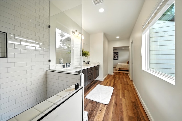 1610 Antoine Dr, Houston, TX 77055 - ensuite bathroom featuring double vanity, wood finished floors, and recessed lighting