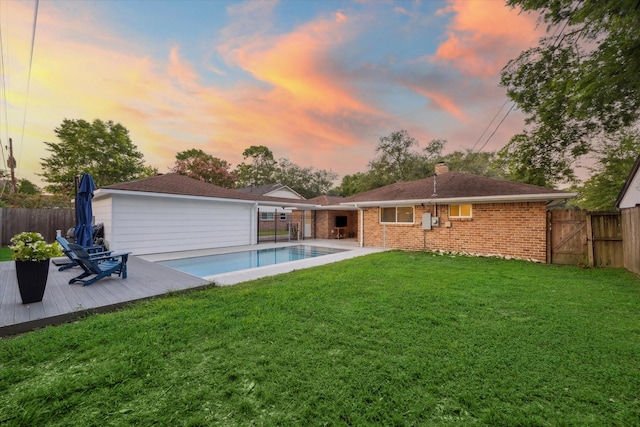 4611 Dunsmere St, Houston, TX 77018 - back of house at dusk with a fenced backyard, a deck, brick siding, and a chimney