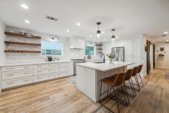 4611 Dunsmere St, Houston, TX 77018 - kitchen featuring open shelves, appliances with stainless steel finishes, recessed lighting, light wood-type flooring, and a kitchen breakfast bar