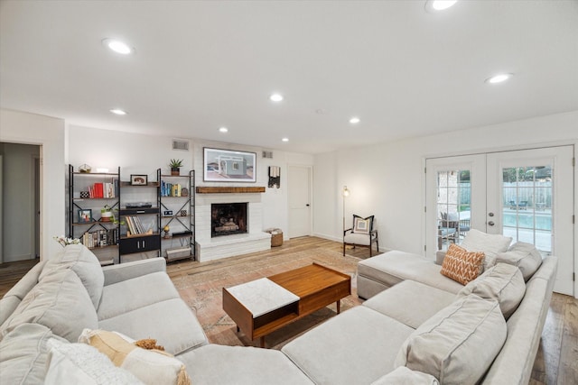 4611 Dunsmere St, Houston, TX 77018 - living room with wood finished floors, french doors, recessed lighting, and a fireplace