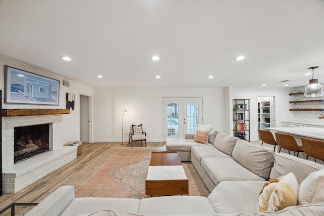 4611 Dunsmere St, Houston, TX 77018 - living room with light wood-style flooring, recessed lighting, a fireplace, and french doors