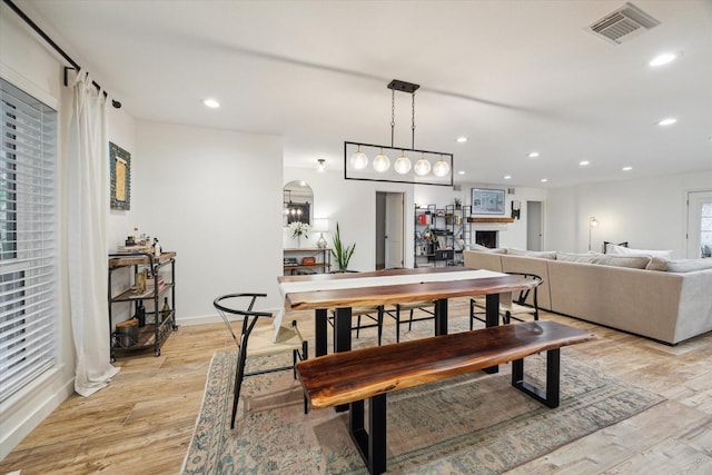 4611 Dunsmere St, Houston, TX 77018 - dining area featuring light wood-type flooring, recessed lighting, and arched walkways