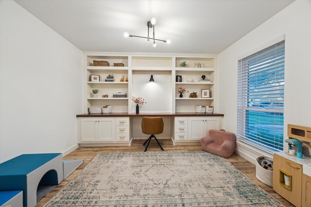 4611 Dunsmere St, Houston, TX 77018 - home office featuring built in desk, a chandelier, and light wood-style floors