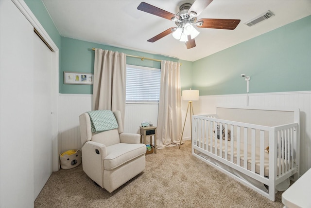 4611 Dunsmere St, Houston, TX 77018 - carpeted bedroom with wainscoting, a nursery area, a closet, and a ceiling fan