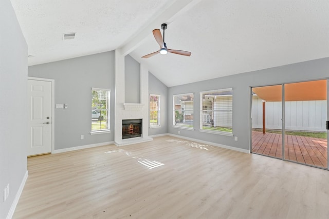 9323 Goodmeadow Dr, Houston, TX 77064 - unfurnished living room with wood finished floors, beam ceiling, a ceiling fan, high vaulted ceiling, and a fireplace