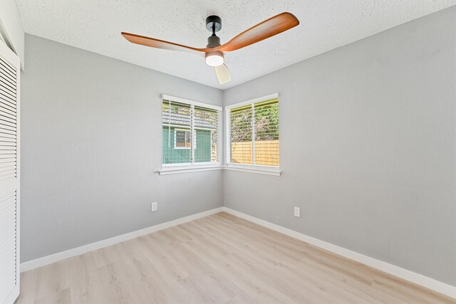 9323 Goodmeadow Dr, Houston, TX 77064 - unfurnished bedroom featuring wood finished floors, a ceiling fan, a closet, and a textured ceiling