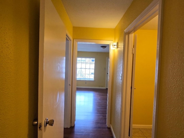 7400 Bellerive Dr Unit 1504, Houston, TX 77036 - hall with a textured wall and dark wood finished floors
