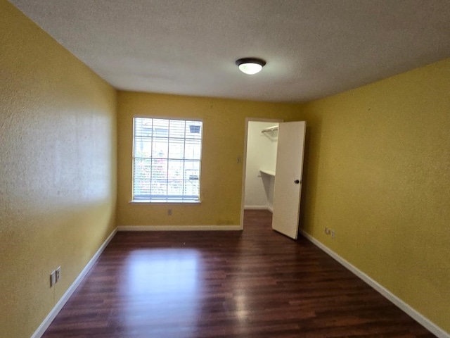 7400 Bellerive Dr Unit 1504, Houston, TX 77036 - spare room featuring wood finished floors, a textured wall, and a textured ceiling