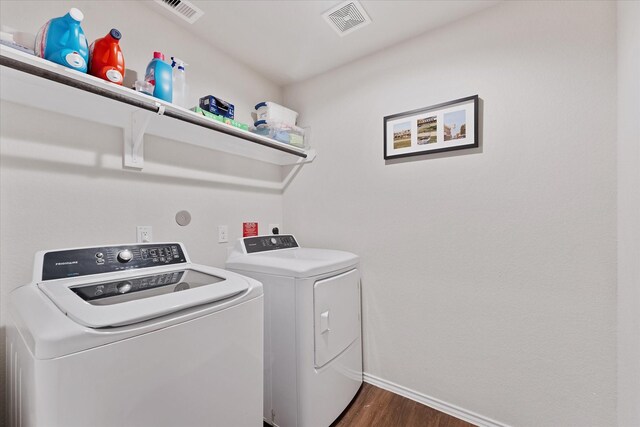 1055 Rancho Grande Dr, Channelview, TX 77530 - laundry area with washing machine and dryer and dark wood-style floors