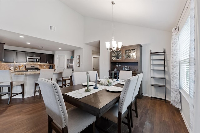 1055 Rancho Grande Dr, Channelview, TX 77530 - dining room featuring vaulted ceiling, a chandelier, and dark wood-type flooring