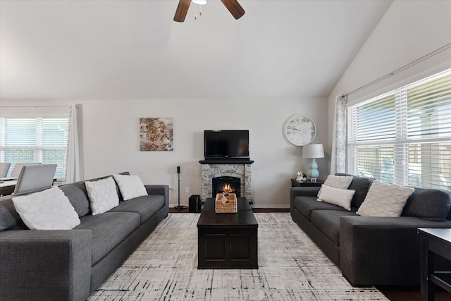 1055 Rancho Grande Dr, Channelview, TX 77530 - living area featuring lofted ceiling, ceiling fan, light wood-style floors, and a stone fireplace