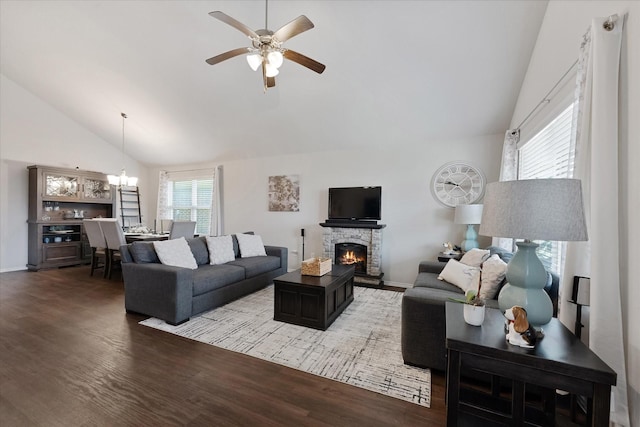 1055 Rancho Grande Dr, Channelview, TX 77530 - living area featuring a ceiling fan, wood finished floors, a stone fireplace, a chandelier, and high vaulted ceiling