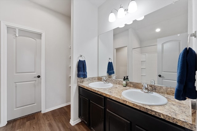 1055 Rancho Grande Dr, Channelview, TX 77530 - bathroom with double vanity, wood finished floors, and a shower