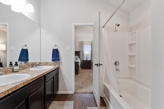 1055 Rancho Grande Dr, Channelview, TX 77530 - ensuite bathroom with shower / bath combination with curtain, wood finished floors, and double vanity