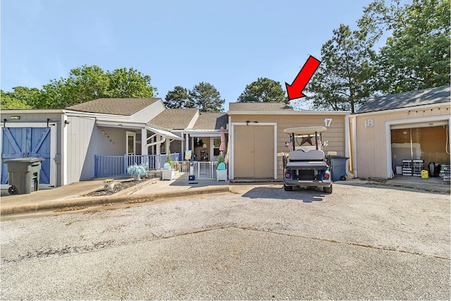 17 Townhouse Ln, Trinity, TX 75862 - view of front of home featuring roof with shingles and covered porch