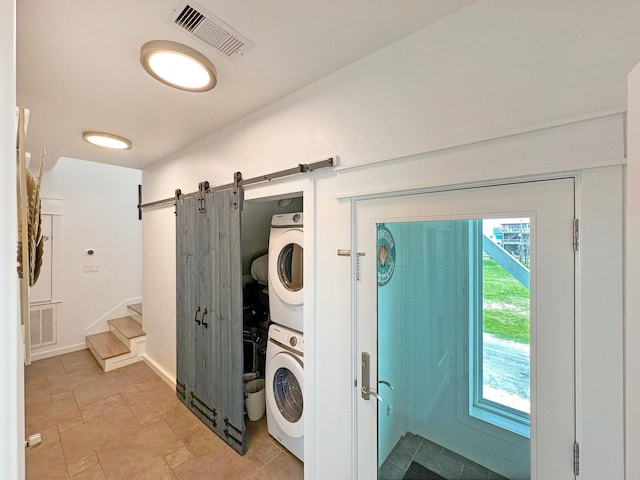 2496 Gilmore, Crystal Beach, TX 77650 - laundry room with stacked washer / dryer and a barn door