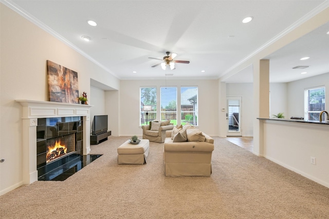 2513 Garnetfield Ln, Friendswood, TX 77546 - carpeted living area with crown molding, a tiled fireplace, recessed lighting, and ceiling fan