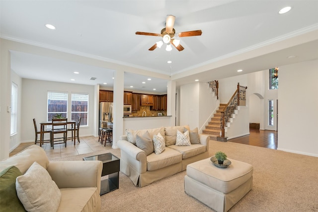 2513 Garnetfield Ln, Friendswood, TX 77546 - living room with recessed lighting, crown molding, a ceiling fan, arched walkways, and stairs