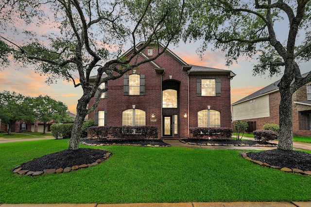 2513 Garnetfield Ln, Friendswood, TX 77546 - traditional home featuring a lawn and brick siding