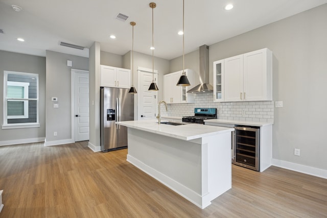 812 Thornton St Unit D, Houston, TX 77018 - kitchen featuring stainless steel fridge with ice dispenser, wine cooler, stove, wall chimney range hood, and decorative backsplash